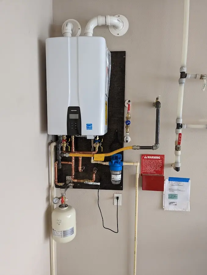 Professional plumber installing copper piping in a Riverwoods home